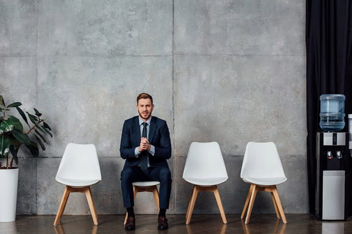 male-sitting-in-an-open-area
